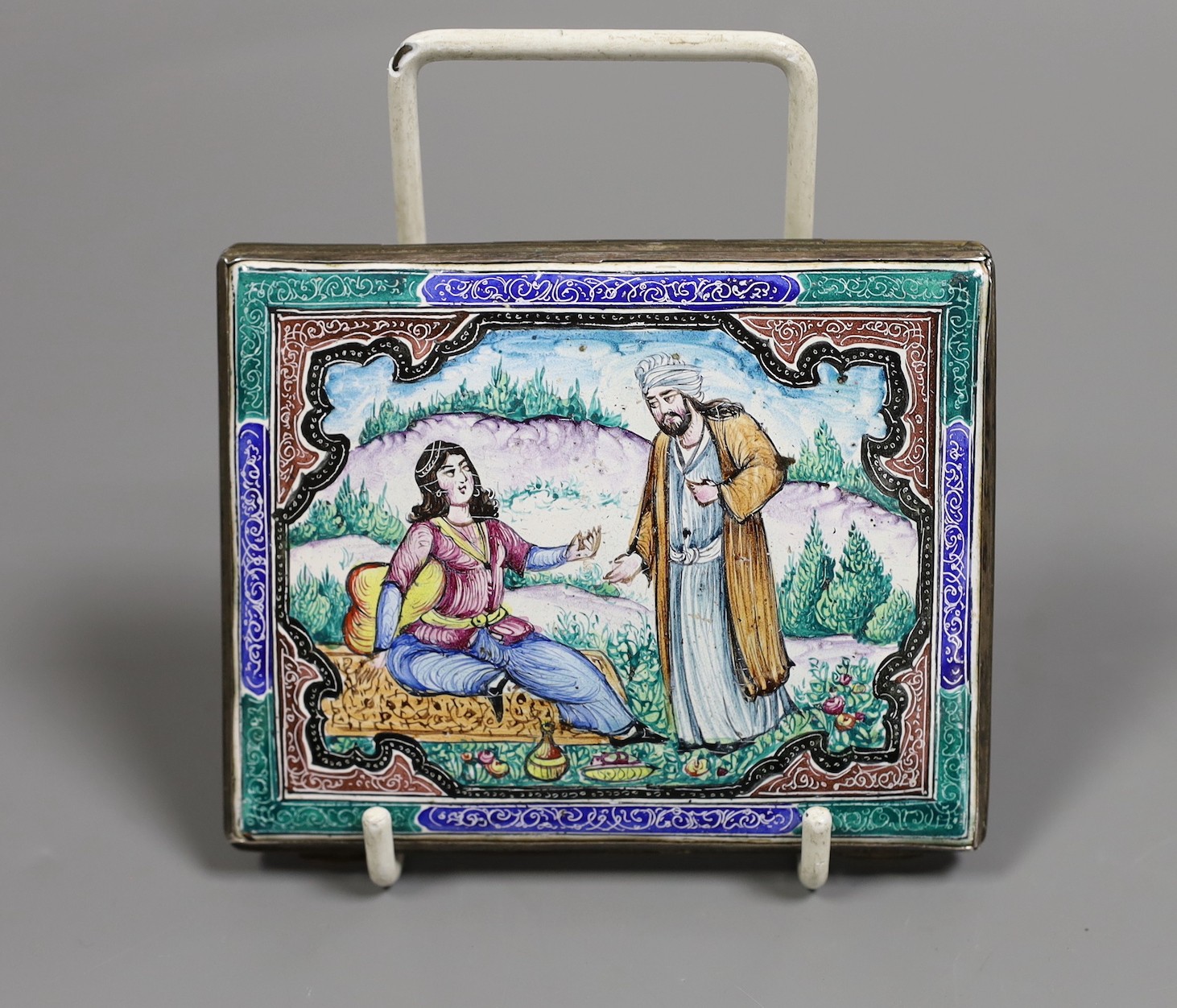 A Persian enamelled cigarette case, 10 cms wide